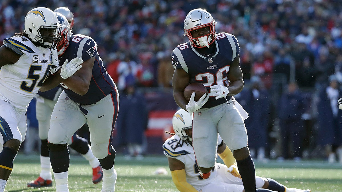 New England Patriots running back Sony Michel heads for the goal line and his second touchdown during the first half of an NFL divisional playoff football game against the Los Angeles Chargers.