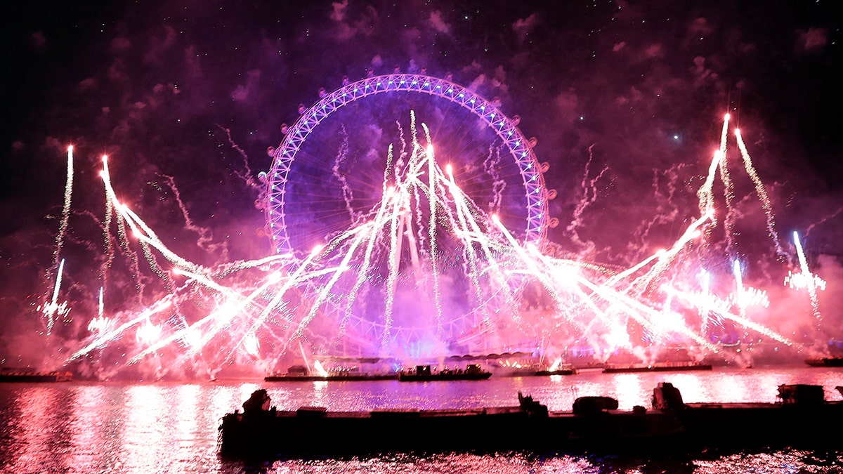 Fireworks explode over the London Eye during the New Year's eve celebrations after midnight in London, Tuesday, Jan. 1, 2019.(AP Photo/Kirsty Wigglesworth)