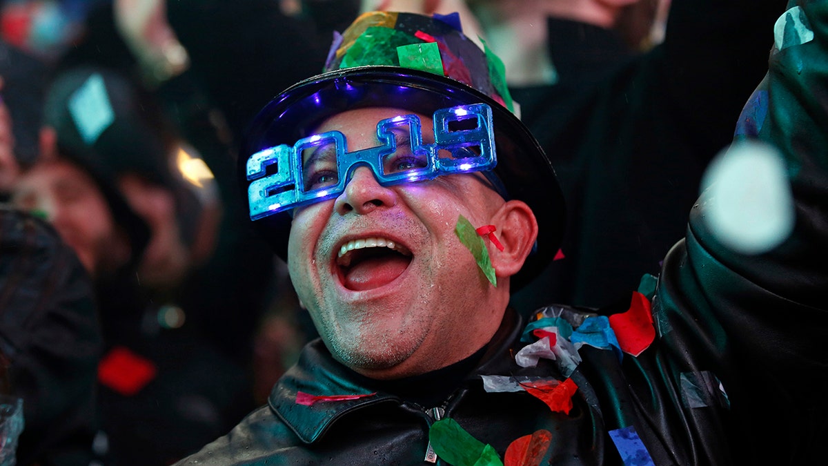 A reveler celebrates as confetti falls during a New Year's celebration in New York's Times Square, Tuesday, Jan. 1, 2019. (AP Photo/Adam Hunger)