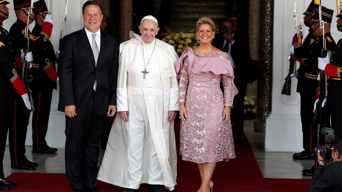 Pope Francis, Panama's President Juan Carlos Varela and first lady Lorena Castillo pose for a photo at entrance of the presidential palace in Panama City, Thursday. (AP Photo/Rebecca Blackwell)