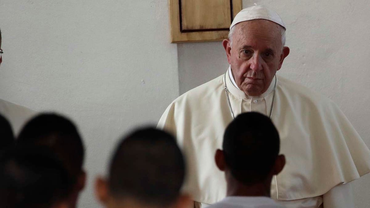 Pope Francis listens to the words of an inmate at the Las Garzas de Pacora detention center for minors before the start of a penitential Mass, in Panama, Friday, Jan. 25, 2019. Francis on Friday denounced how society puts up "invisible walls" to marginalize sinners and criminals as he brought World Youth Day to Panama's juvenile delinquents who can't participate in the Catholic Church's big festival of faith. (AP Photo/Alessandra Tarantino)