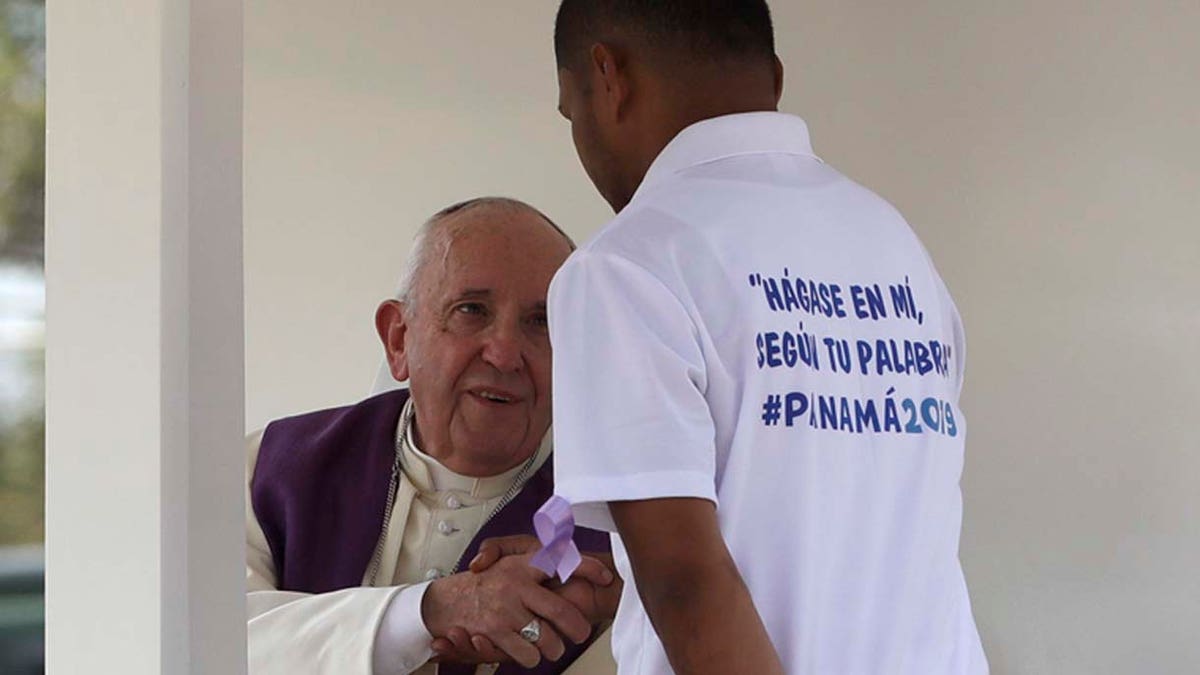 Pope Francis shakes hands with an inmate before he listens to his confession during a penitential liturgy at the Las Garzas de Pacora detention center for minors, in Panama, Friday, Jan. 25, 2019. Francis on Friday denounced how society puts up "invisible walls" to marginalize sinners and criminals as he brought World Youth Day to Panama's juvenile delinquents who can't participate in the Catholic Church's big festival of faith. (AP Photo/Alessandra Tarantino)