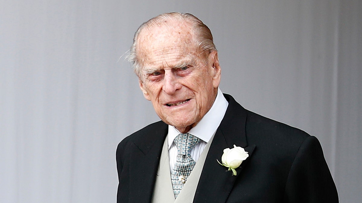 FILE - In this Friday, Oct. 12, 2018 file photo, Britain's Prince Philip waits for the bridal procession following the wedding of Princess Eugenie of York and Jack Brooksbank in St George's Chapel, Windsor Castle, near London, England. Prince Philip, the 97-year-old husband of Queen Elizabeth II, has apologized to a mother-of-two who was injured when the car she was riding in collided with a Land Rover he was driving on Jan. 17, 2019. (AP Photo/Alastair Grant, Pool)