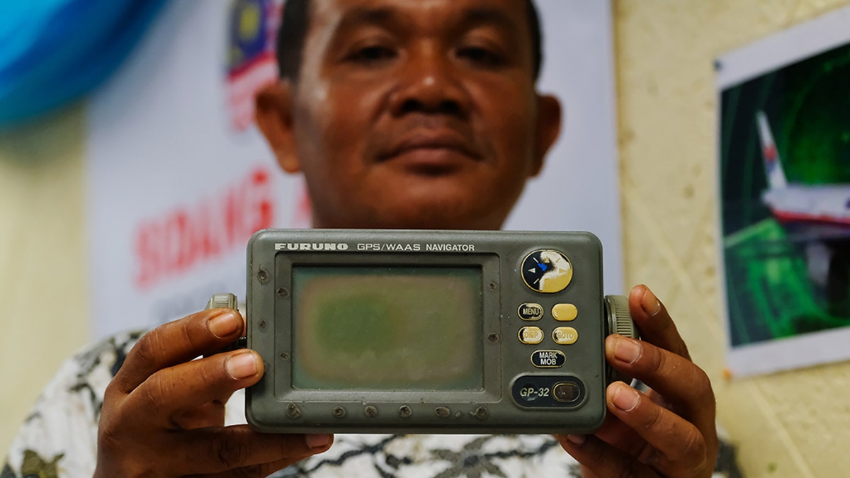 Rusli Khusmin, 42, a fisherman from Indonesia shows his GPS Navigator which he used to record the coordinates of where he believes Malaysia Airlines Flight MH370 crashed into the Sumatra Indonesia Sea during a news conference on January 16, 2019 in Subang Jaya outside Kuala Lumpur, Malaysia.