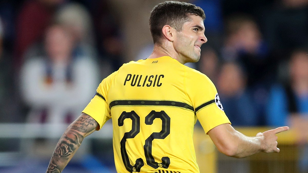 Borussia Dortmund's Christian Pulisic celebrates scoring his side's first goal during a Champions League group A soccer match between Club Brugge and Borussia Dortmund at the Jan Breydel Stadium in Bruges, Belgium.