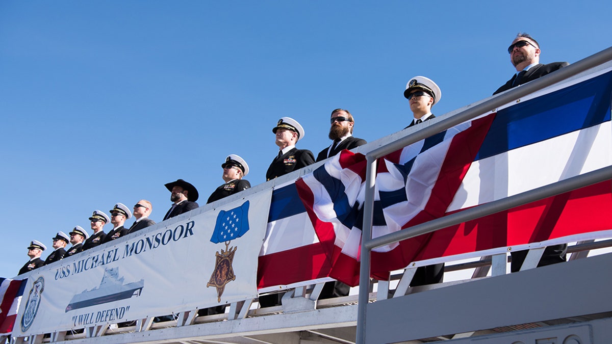 SAN DIEGO (Jan. 26, 2019) Former members of SEAL Team 3 join the ship's crew to bring the Navy's newest Zumwalt-class guided-missile destroyer, USS Michael Monsoor (DDG 1001), to life during its commissioning ceremony. Michael Monsoor is the second Zumwalt destroyer ship to enter the fleet. It is the first Navy combat ship named for fallen Master-at-Arms 2nd Class (SEAL) Michael Monsoor, who was posthumously awarded the Medal of Honor for his heroic actions while serving in Ramadi, Iraq, in 2006. (U.S. Navy photo by Mass Communication Specialist 3rd Class Devin M. Monroe/Released)