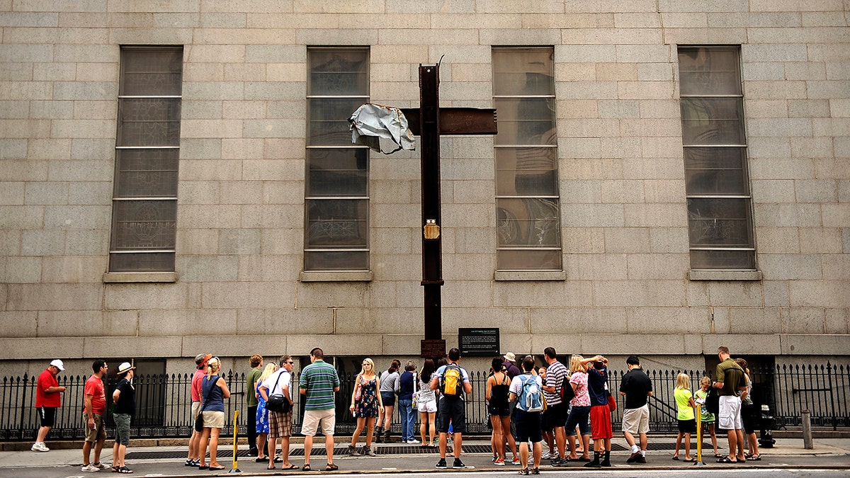 The Cross at Ground Zero was moved to St. Peter's Church on October 5, 2006. Visitors pass by on Church Street between Barclay and Vesey Streets. A welded steel plaque reads "The Cross at Ground Zero - Founded September 13, 2001; Blessed October 4, 2001; Temporarily Relocated October 5, 2006. Will return to WTC Museum, a sign of comfort for. Joe Amon, The Denver Post (Photo By Joe Amon/The Denver Post via Getty Images)