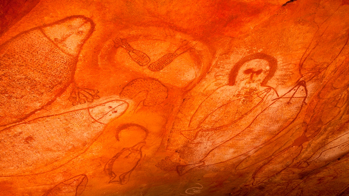Aboriginal cave paintings in rock shelter with Wandjina spirit figure and marine life. Raft Point Gallery, Kimberley Region, Western Australia, Australia. (Photo by: Auscape/UIG via Getty Images)