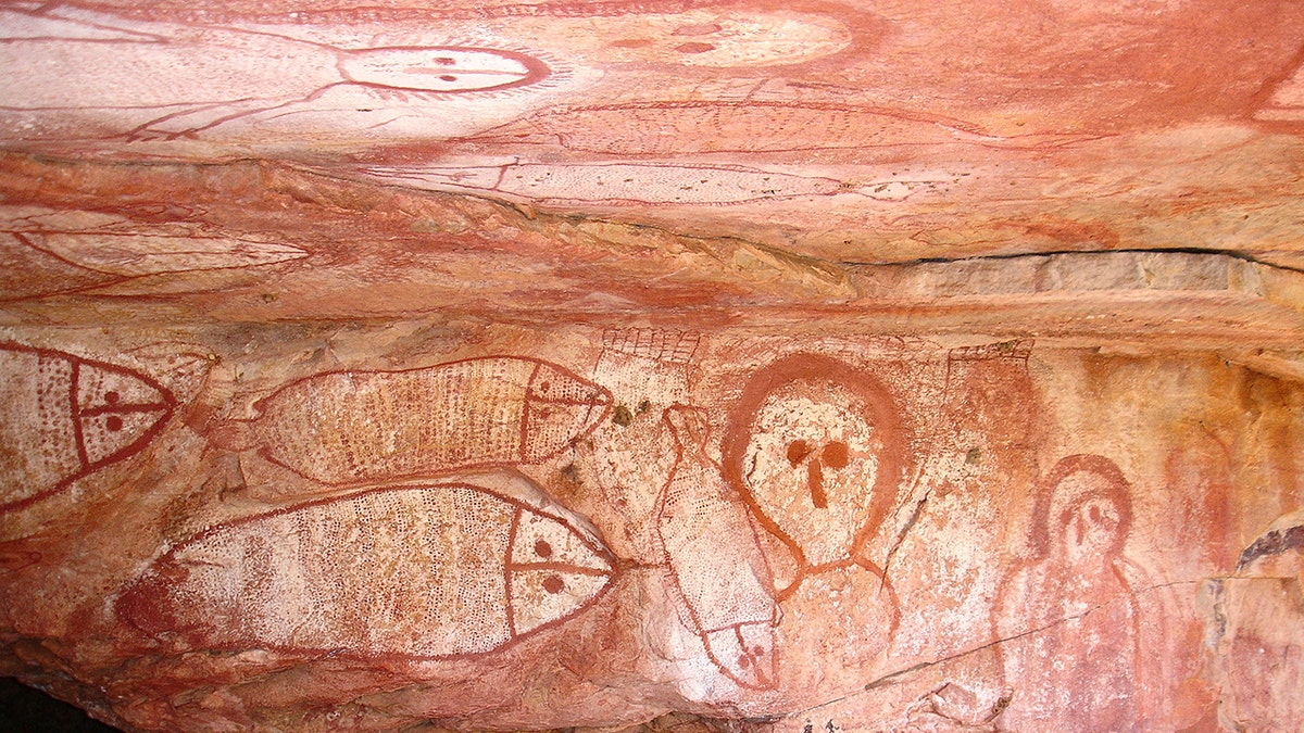 Aboriginal cave paintings in rock shelter - Gwion Gwion (formerly called Bradshaw) rock art, depicting a fish hunt. Raft Point Gallery, Kimberley Region, Western Australia. (Photo by Auscape/UIG via Getty Images)
