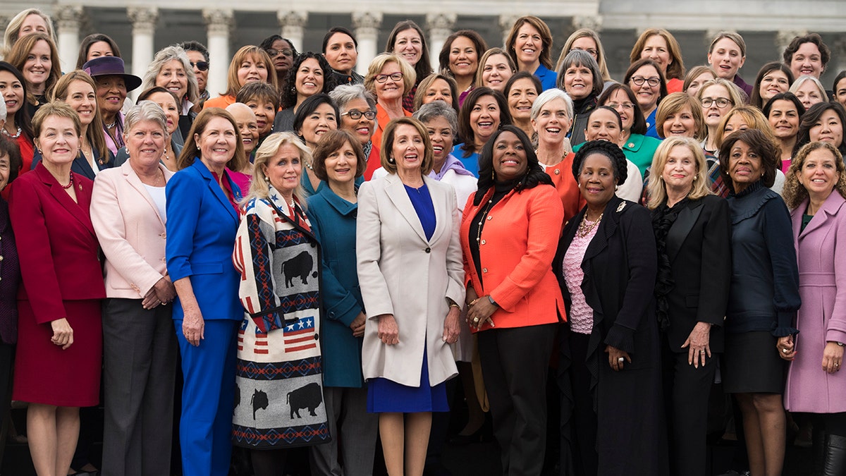 UNITED STATES - JANUARY 04: Speaker Nancy Pelosi, D-Calif., center, poses with Democratic women members of the House after a group photo on the East Front of the Capitol on January 4, 2019. (Photo By Tom Williams/CQ Roll Call)