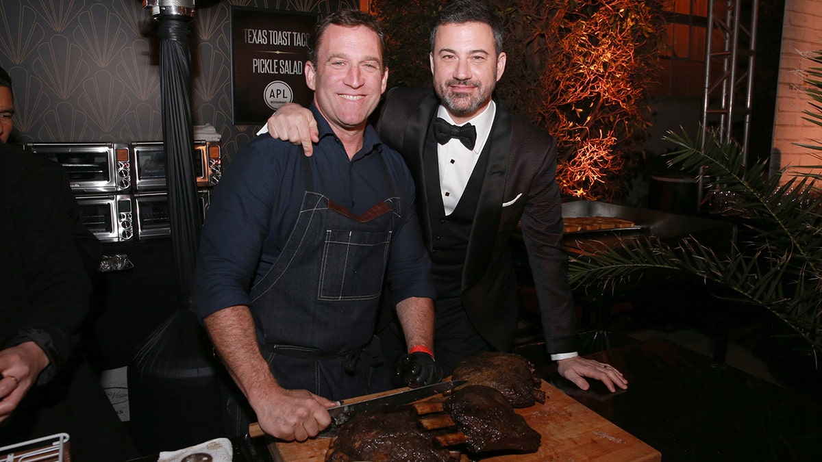 LOS ANGELES, CA - MARCH 04:  Chef Adam Perry Lang (L) prepares Jimmy Kimmel a Texas Toast Taco at Jimmy Kimmel's post-show after-party for Hollywood's biggest night at The Lot on March 4, 2018 in West Hollywood, California.  (Photo by Rich Fury/Getty Images for Jimmy Kimmel)