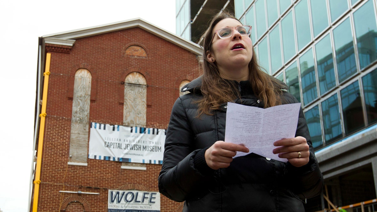 Rabbi Hannah Spiro of Hill Havurah offers a traditional Jewish traveler's prayer, before workers move the Adas Israel Synagogue, the oldest synagogue in Washington, to a new location, which will be part of the new Capital Jewish Museum on Wednesday, Jan. 9, 2019, in Washington . (AP Photo/Jose Luis Magana)