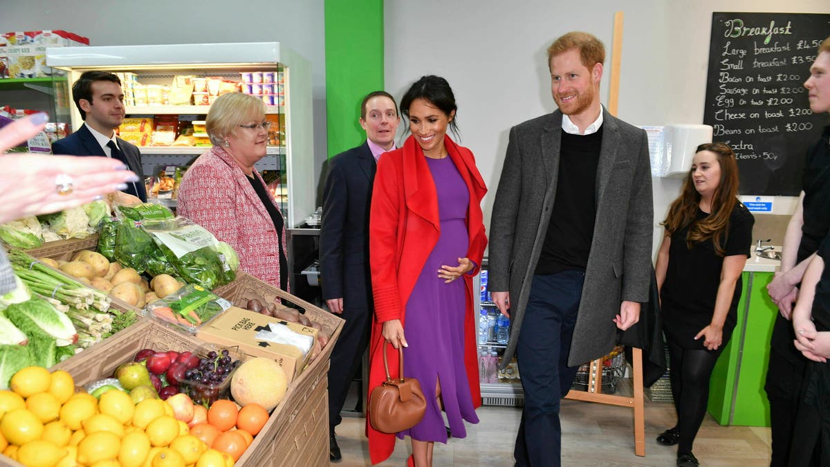 Britain's Prince Harry and Meghan, Duchess of Sussex officially open Number 7, a 'Feeding Birkenhead' citizens supermarket and community cafe, at Pyramids Shopping Centre, as part of a visit to Birkenhead, northwest England, Monday Jan. 14, 2019. (Anthony Devlin/Pool via AP)