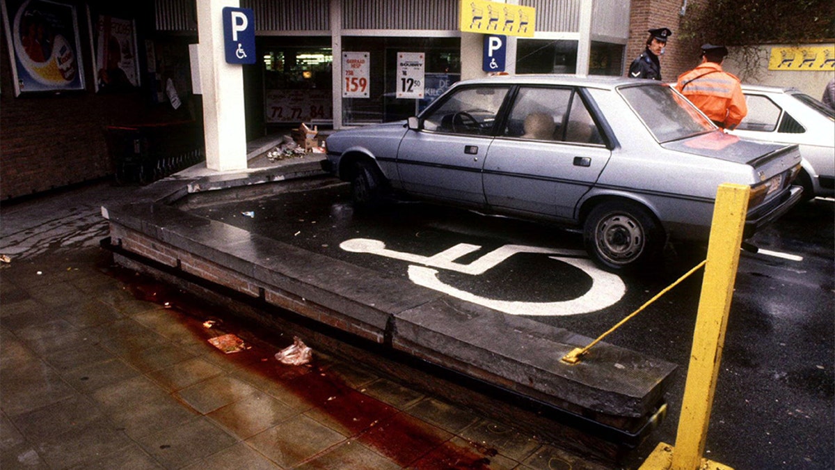 View of the parking lot of a Delhaize supermarket in Alost November 10, 1985, the day after an attack by the "Brabant killers". Police have failed to solve the "Brabant Killings" when a band of gunmen sowed terror in central Belgium between 1983 and 1985 by attacking supermarkets and indiscriminately shooting customers. At least 28 people died in the attacks.