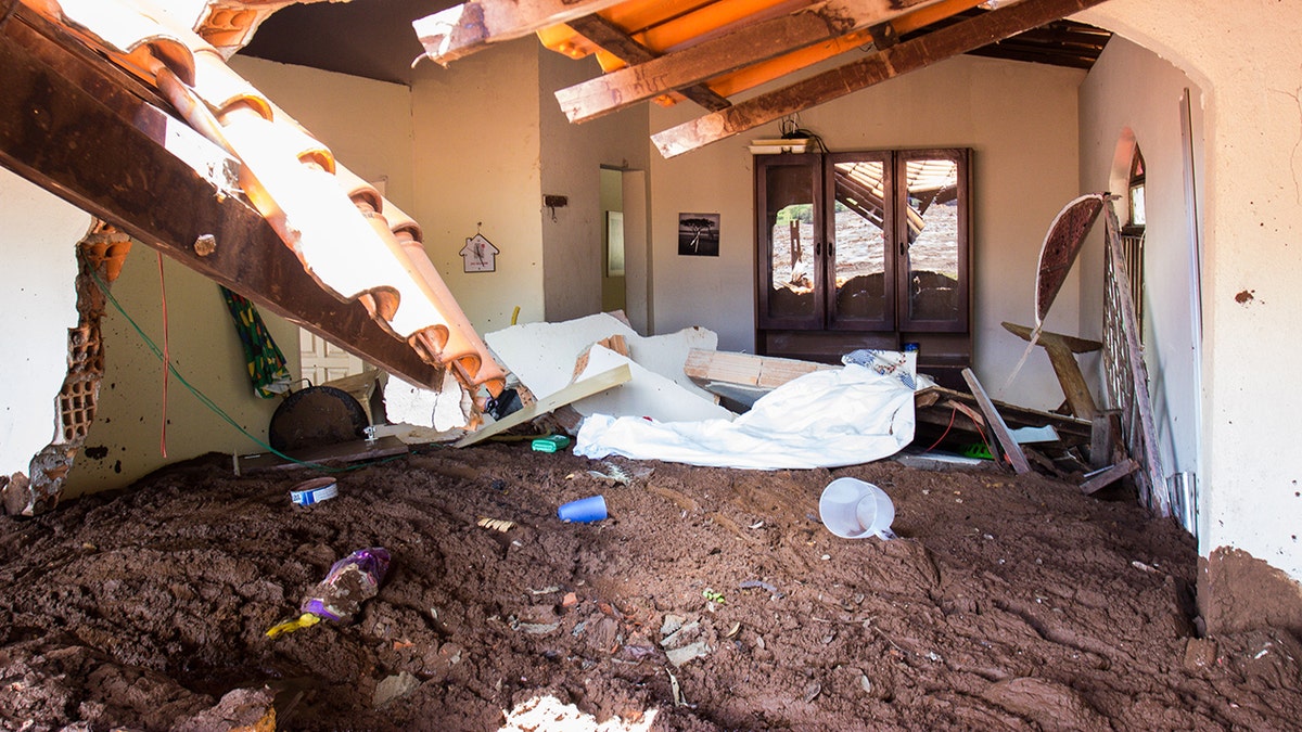 Drying mud lies high in a house affected by the mud avalanche caused by the broken dam. (Photo by Rodney Costa/picture alliance via Getty Images)