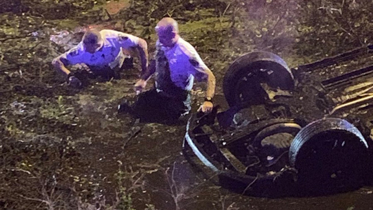 Hillsborough County deputies in Florida rescued a woman who called 911 after flipping her car into "water and muck" off Interstate 4.
