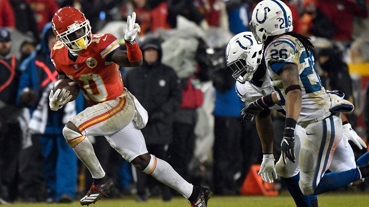 Kansas City Chiefs wide receiver Tyreek Hill (10) gestures as he runs past Indianapolis Colts safety Clayton Geathers (26) and linebacker Anthony Walker during the second half of an NFL divisional football playoff game in Kansas City, Mo., Saturday, Jan. 12, 2019. (Associated Press)