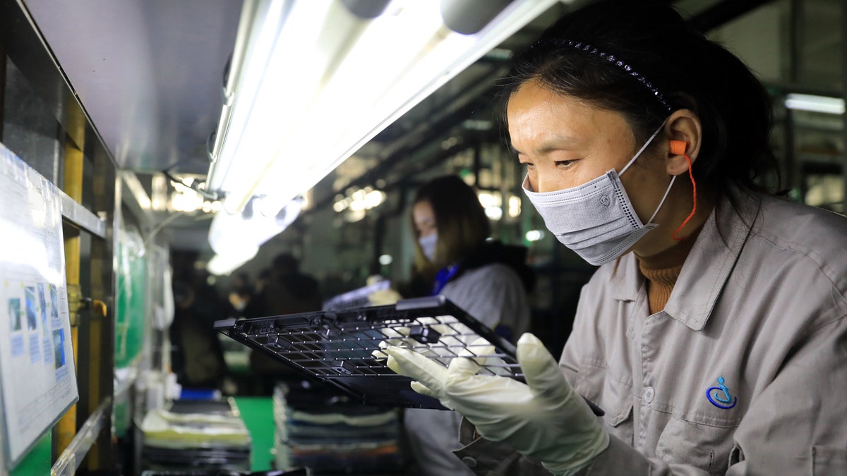 This photo taken on November 19, 2018 shows workers checking laptop parts in a factory in the Hangyong Auto Industrial Park, in Lu'an City, in China's Anhui Province. STR/AFP/Getty Images