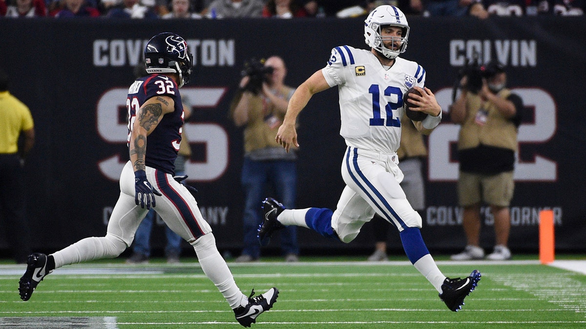 Indianapolis Colts quarterback Andrew Luck (12) runs as Houston Texans free safety Tyrann Mathieu (32) peruses during the second half of an NFL wild card playoff football game, Saturday, Jan. 5, 2019, in Houston. (Associated Press)