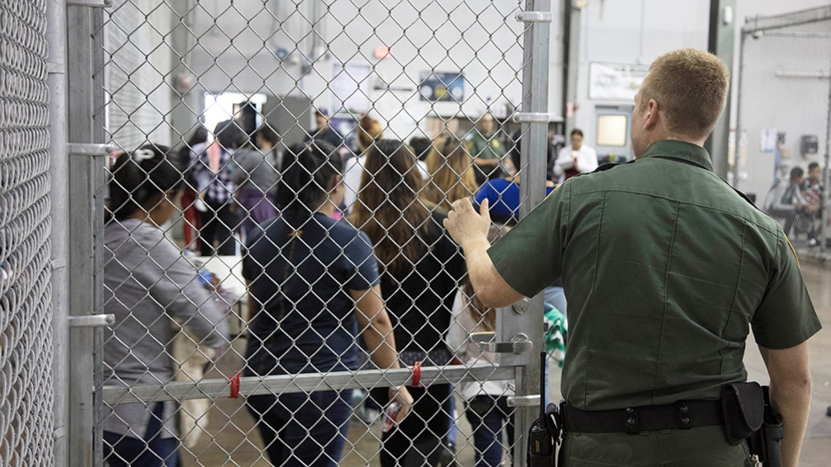 A view of inside U.S. Customs and Border Protection (CBP) detention facility shows detainees inside fenced areas at Rio Grande Valley Centralized Processing Center in Rio Grande City, Texas, in June. 