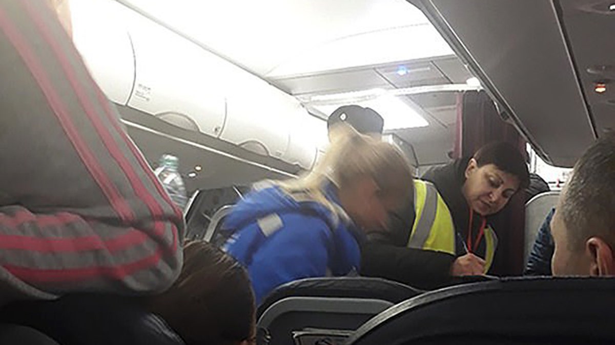 At least five passengers reported feeling ill during the flight.