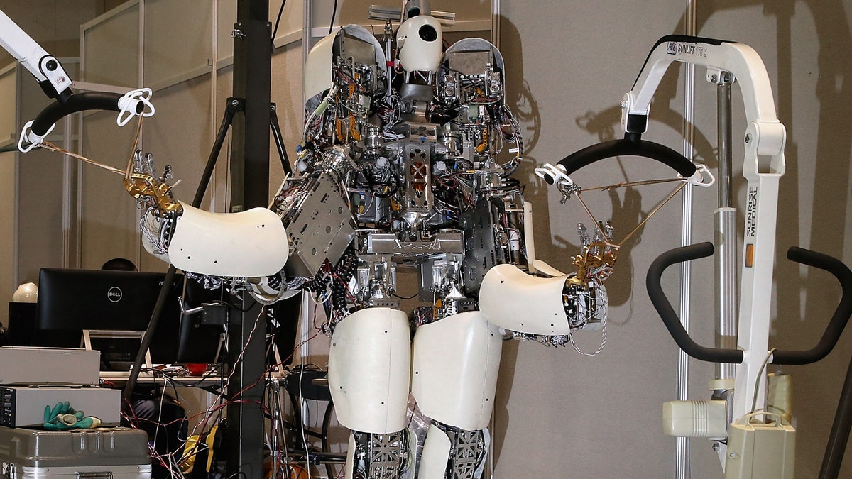 Team NEDO-Hydra's robot is held in place by racks inside the Robot Garage during the Defense Advanced Research Projects Agency (DARPA) Robotics Challenge, June 6, 2015 in Pomona, California. 
