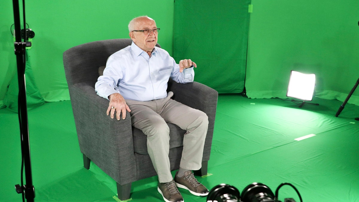 This August 2018 photo shows Holocaust survivor Max Glauben sitting in an interactive green screen room while filming a piece for the Dallas Holocaust Museum in Dallas.