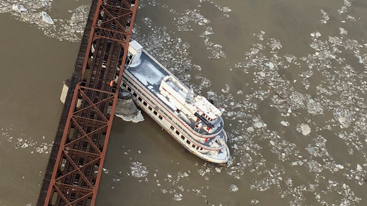 The Captain JP III cruise ship is wedged against the Livingston Avenue train bridge that spans the Hudson River, Friday, Jan. 25, 2019 in Albany, N.Y.