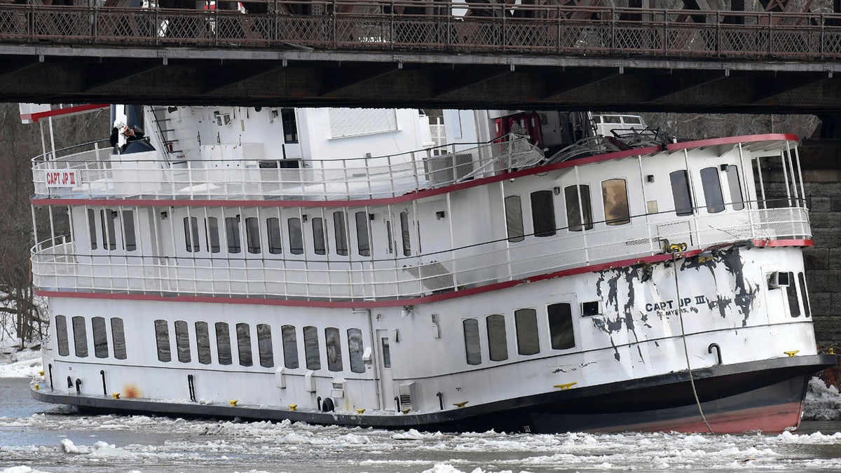 Captain JP III cruise ship is wedged against the Livingston Avenue train bridge that spans the Hudson River in Albany, N.Y., Friday, Jan. 25, 2019.