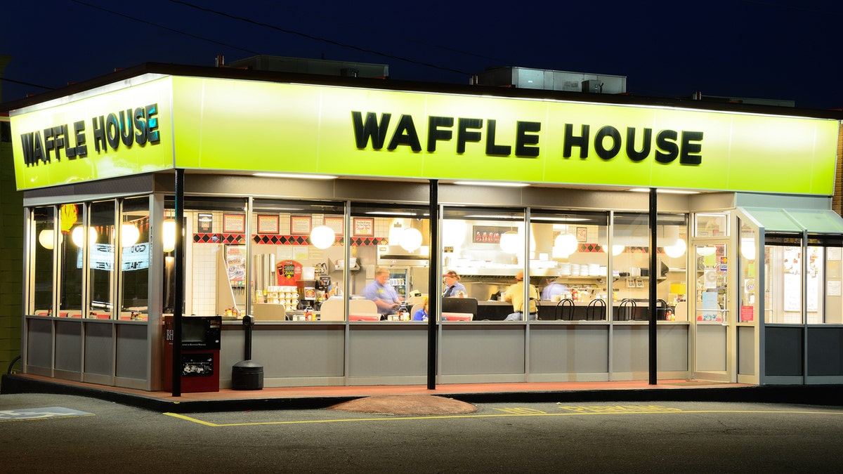 A couple took their love for Waffle House to an extreme at their wedding – by having a cake modeled to look like the façade of the restaurant.