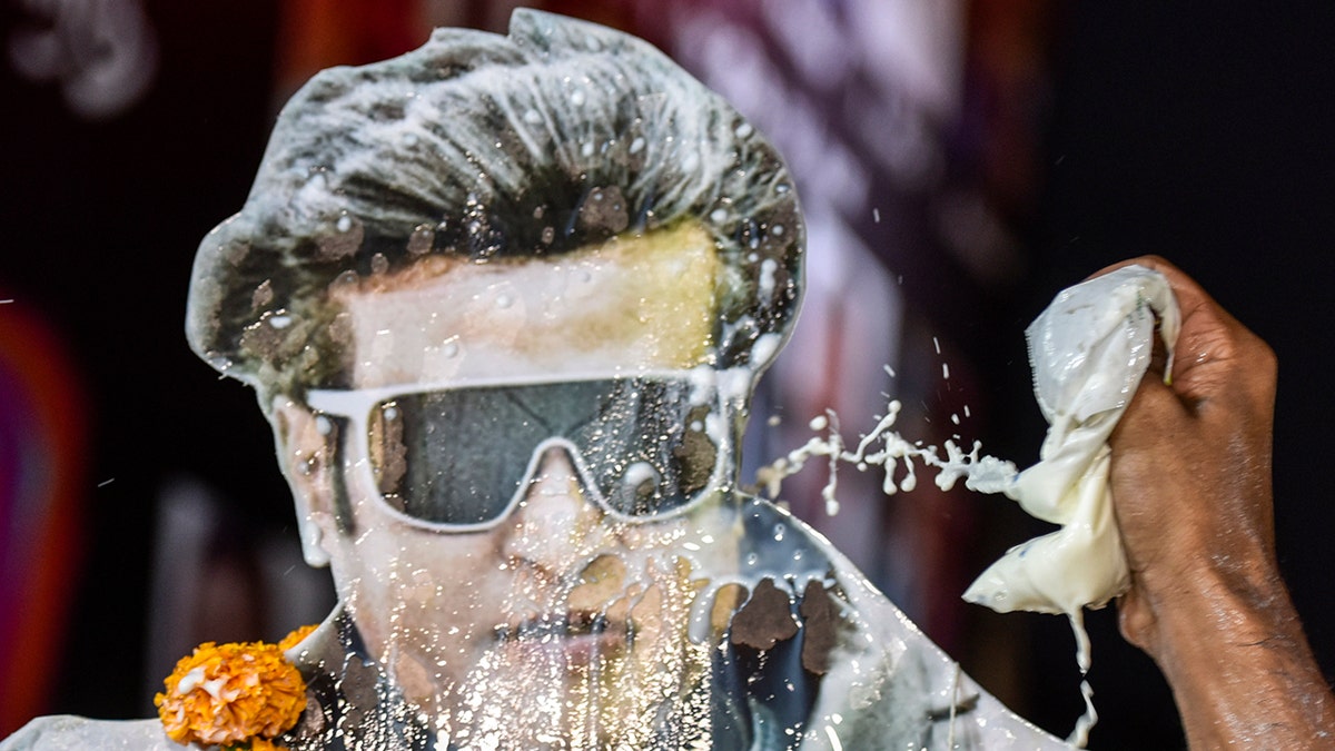 Fans of actor Rajinikanth spray milk as they celebrates the release of his long awaited film '2.0' at Imax Wadala on November 29, 2018 in Mumbai, India.