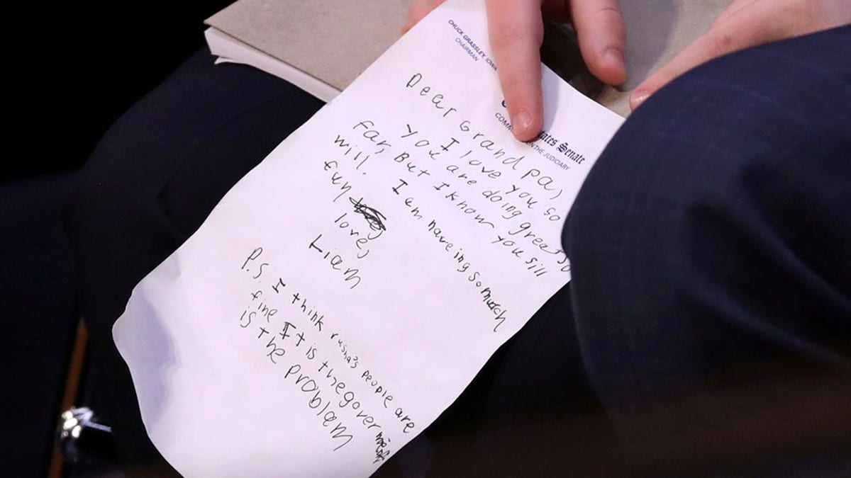 William Barr's young grandson Liam wrote a note during his attorney general confirmation hearing, commenting on his performance during the questioning and Russia.