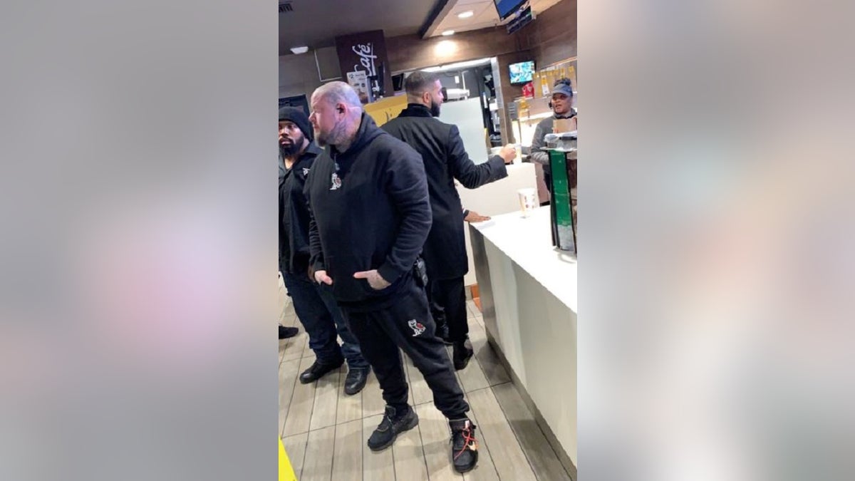 Drake appears to hand a hefty tip to McDonald's employees in Los Angeles last weekend.
