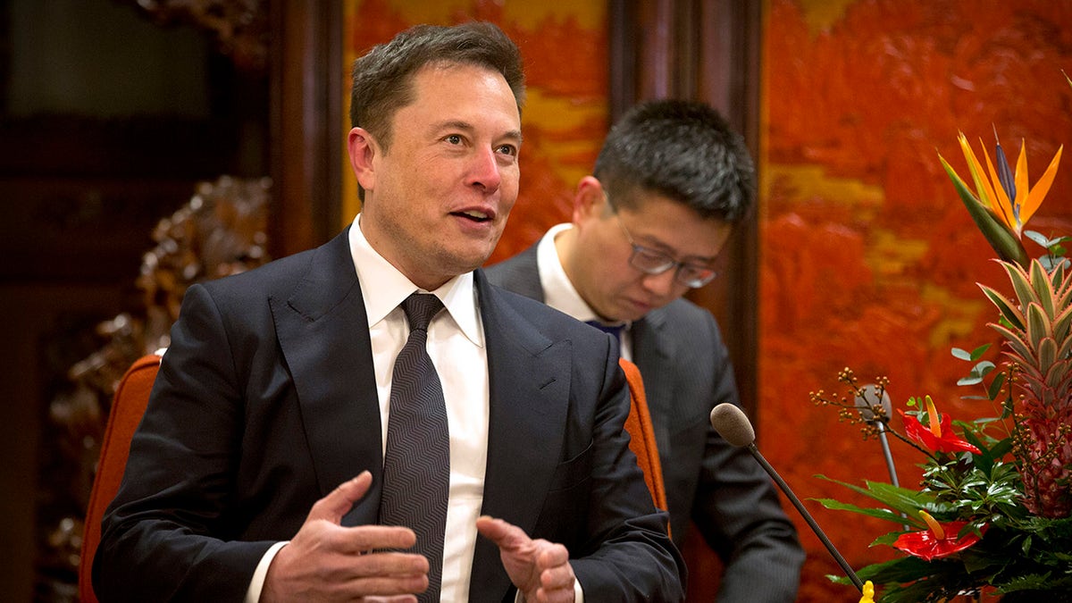 FILE - In this Jan. 9, 2019, file photo, Tesla CEO Elon Musk speaks during a meeting with Chinese Premier Li Keqiang at the Zhongnanhai leadership compound in Beijing. (AP Photo/Mark Schiefelbein, Pool, File)