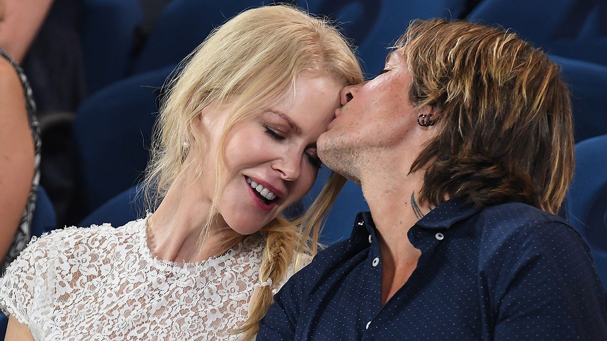 MELBOURNE, AUSTRALIA - JANUARY 24: Nicole Kidman and Keith Urban share an affectionate moment during one of the women's semi finals on Rod Laver Arena as they attend the 2019 Australian Open at Melbourne Park on January 24, 2019 in Melbourne, Australia. (Photo by James D. Morgan/Getty Images)