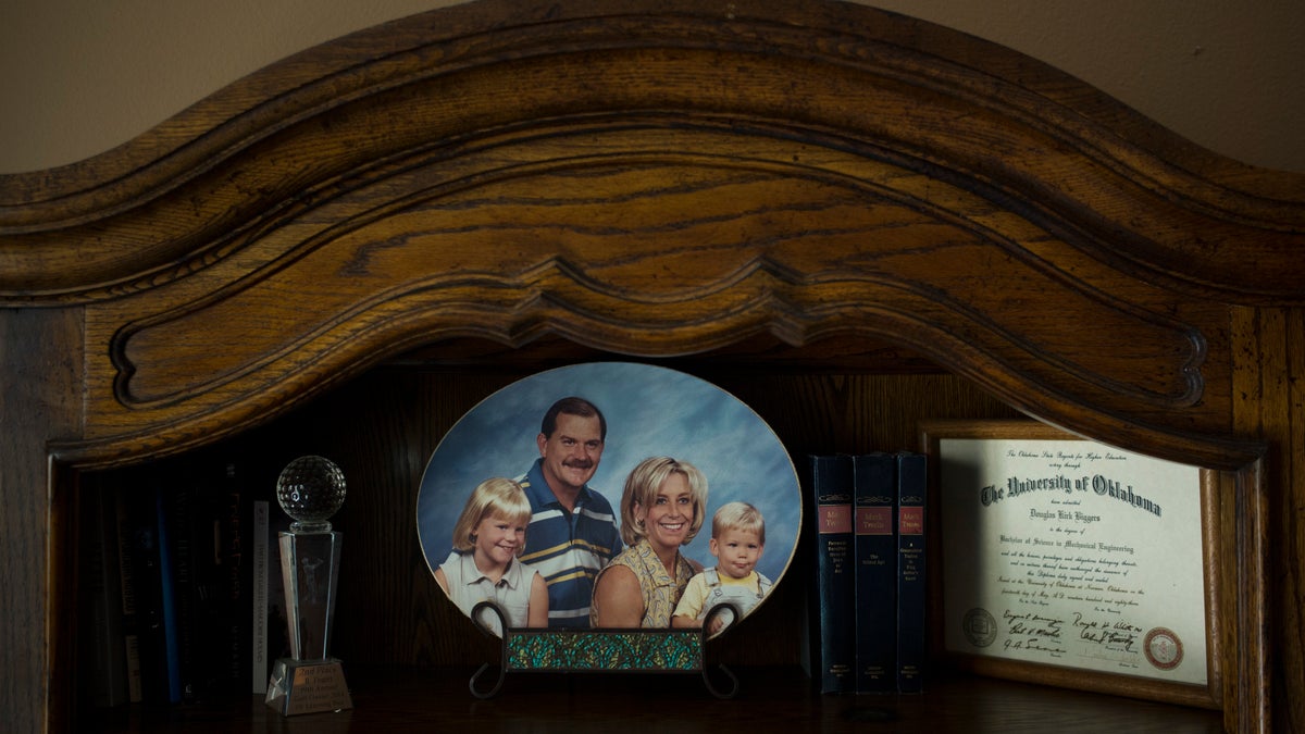 Landon Biggers sits on his mother’s lap in an old family photo in his father’s home office in La Quinta, Calif.