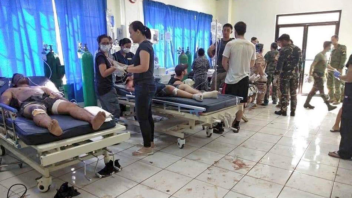 Bomb victims receive treatment in a hospital after two bombs exploded outside a Roman Catholic cathedral in Jolo, the capital of Sulu province in southern Philippines where militants are active Sunday, Jan. 27, 2019. (WESMINCOM Armed Forces of the Philippines Via AP)