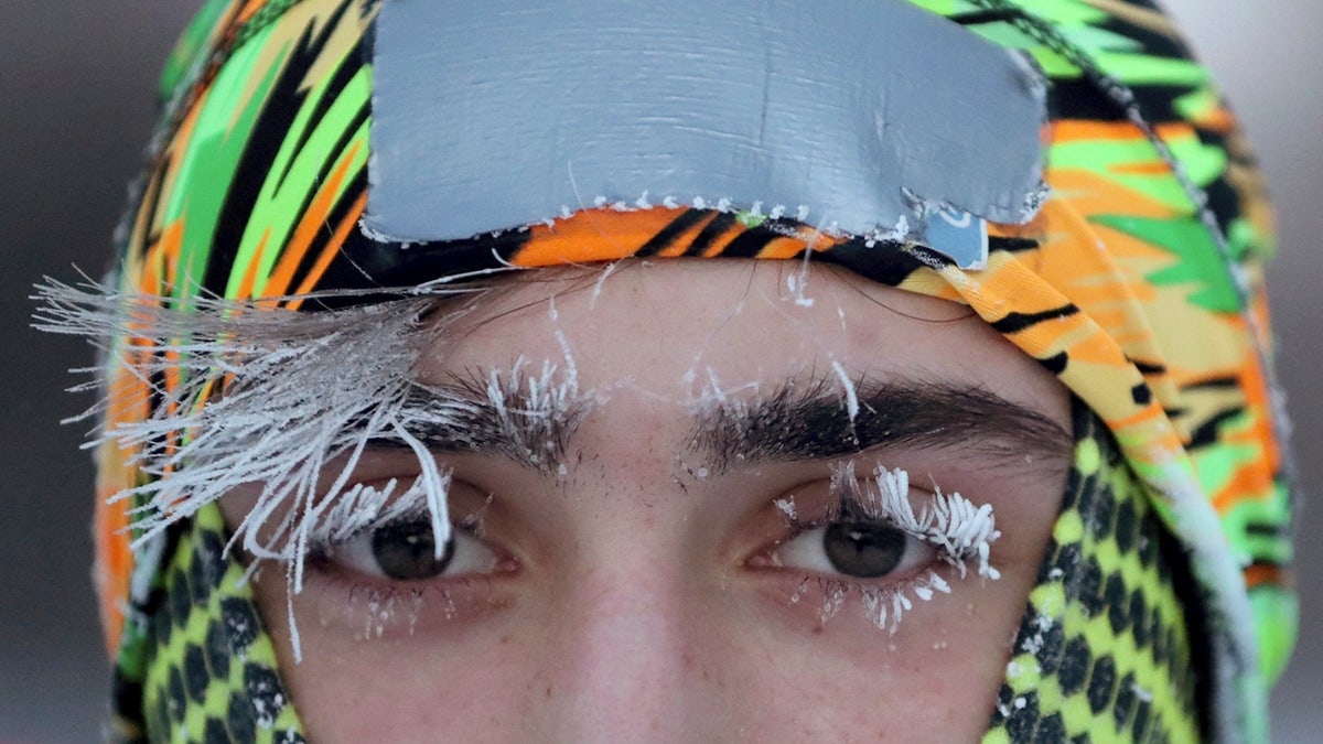 Frost covers part of the face of University of Minnesota student Daniel Dylla during a morning jog along Mississippi River Parkway Tuesday, Jan. 29, 2019, in Minneapolis.