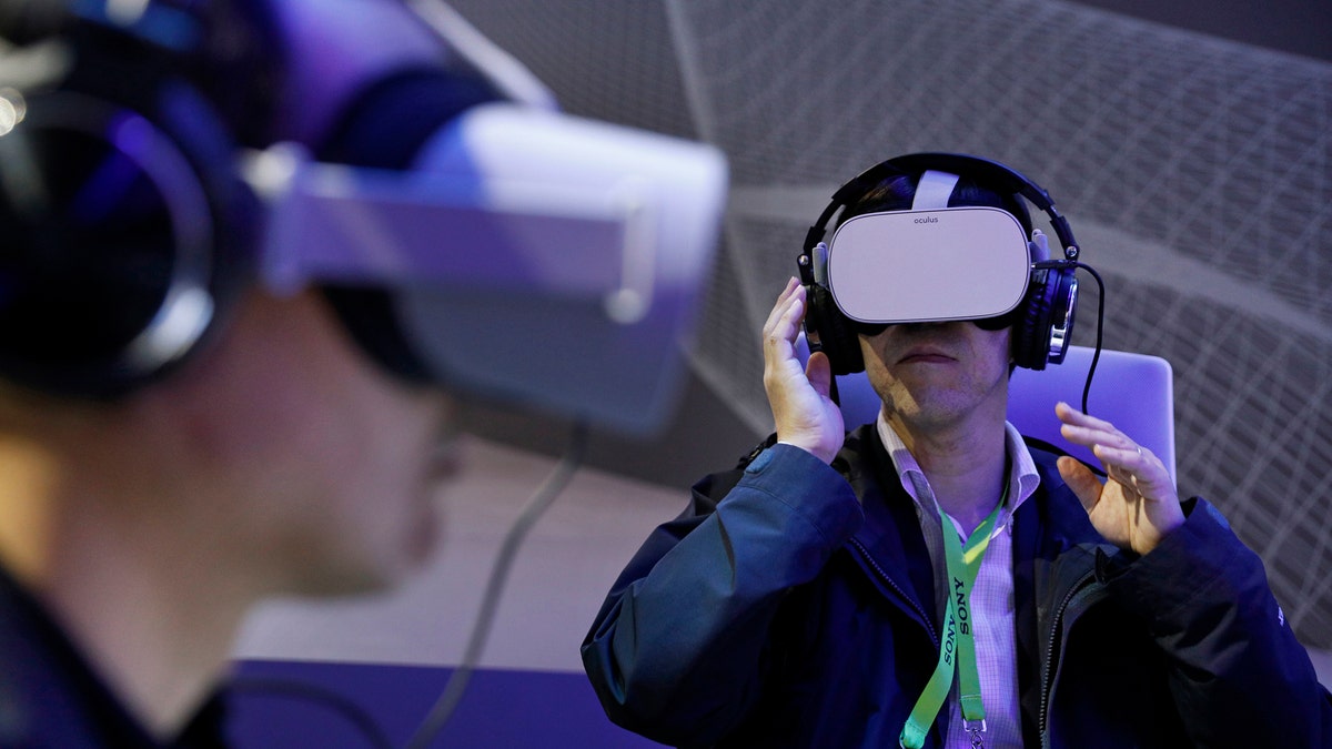 People use Oculus VR headsets at the Panasonic booth at CES International, Tuesday, Jan. 8, 2019, in Las Vegas. (AP Photo/John Locher)