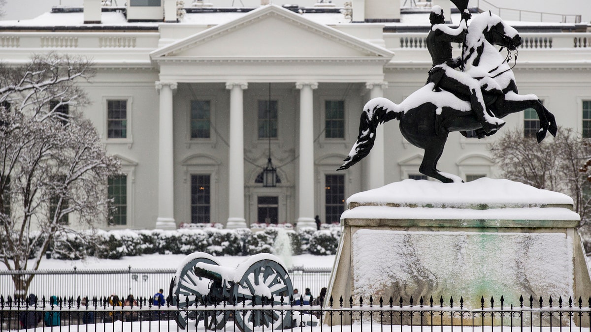 Snow blankets a statue of Andrew Jackson in Lafayette Square with the White House behind, as a winter storm arrives in the region, Sunday, Jan. 13, 2019, in Washington.