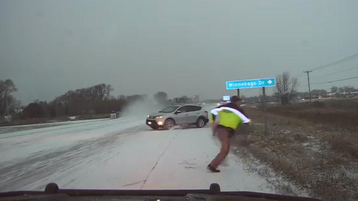 Deputy Jason Fabry was assisting a driver who slid into the ditch when an oncoming motorist lost control and nearly hit him.