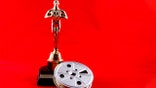 New Cumberland, PA, USA - February 3, 2015 : Illustrative editorial showing the Academy Awards statue known as Oscar with an old time movie reel on the iconic red carpet