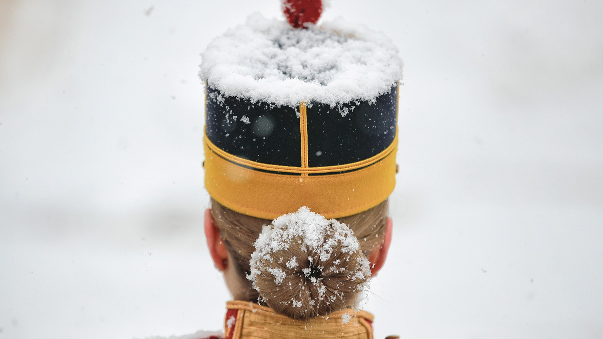 Snow falls on an honor guard soldier before the welcoming ceremony for Slovenia's President Borut Pahor at the Cotroceni presidential palace in Bucharest, Romania, Jan. 15, 2019.