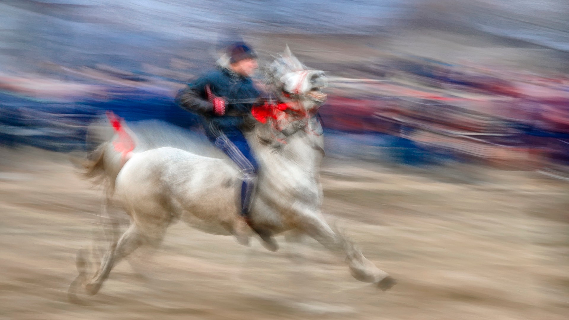 A man warms up his horse before an Epiphany celebration horse race in Pietrosani, Romania, Jan. 6, 2019.