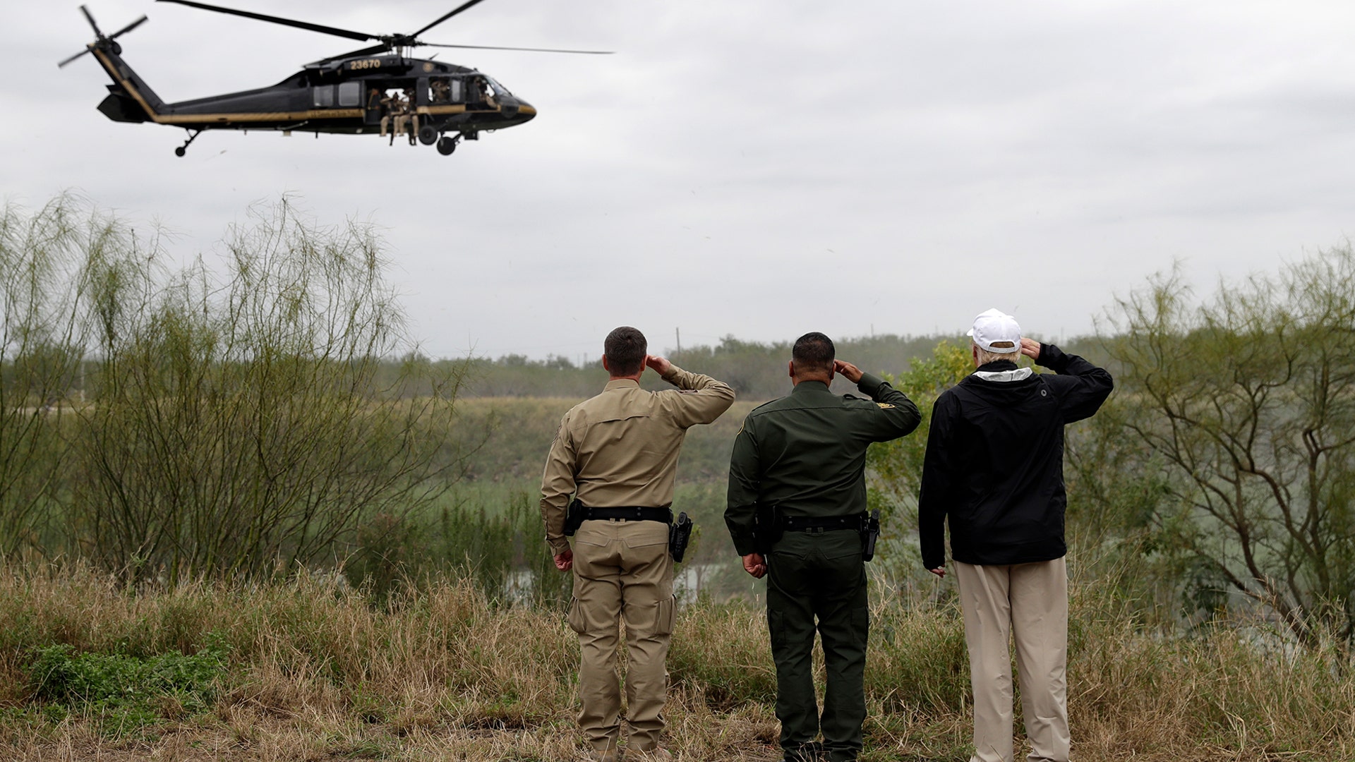 President Donald Trump salutes as he tours the U.S. border with Mexico at the Rio Grande on the southern border, in McAllen, Texas, Jan. 10, 2019.