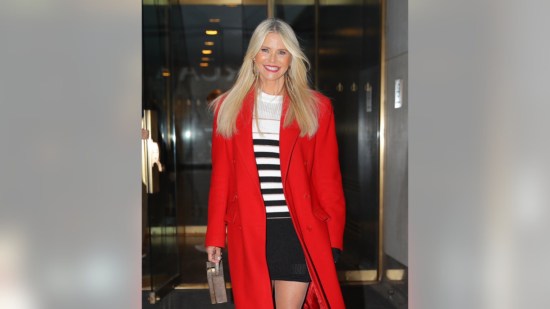 Christie Brinkley is all smiles while leaving the "Today" show wearing a red coat in New York City.