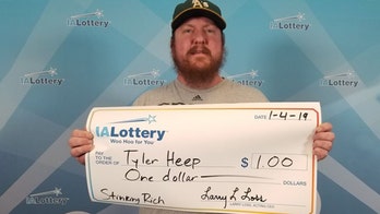 Iowa man wins $1 in lottery, celebrates with giant check