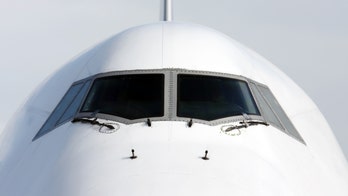 Pilot caught on camera trying to climb into cockpit through plane window