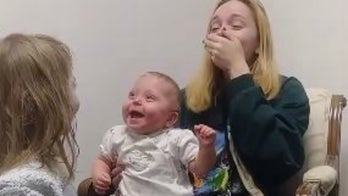 Baby erupts in laughter after hearing clearly for first time