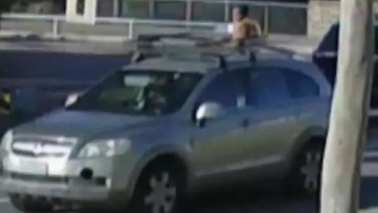 Australian mother appears to drive away with child, 4, on roof of car